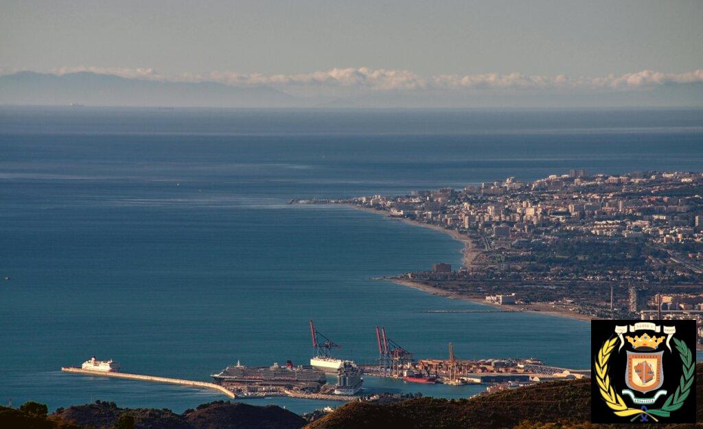A breathtaking aerial cityscape showcasing Málaga's beautiful coastline and bustling port.