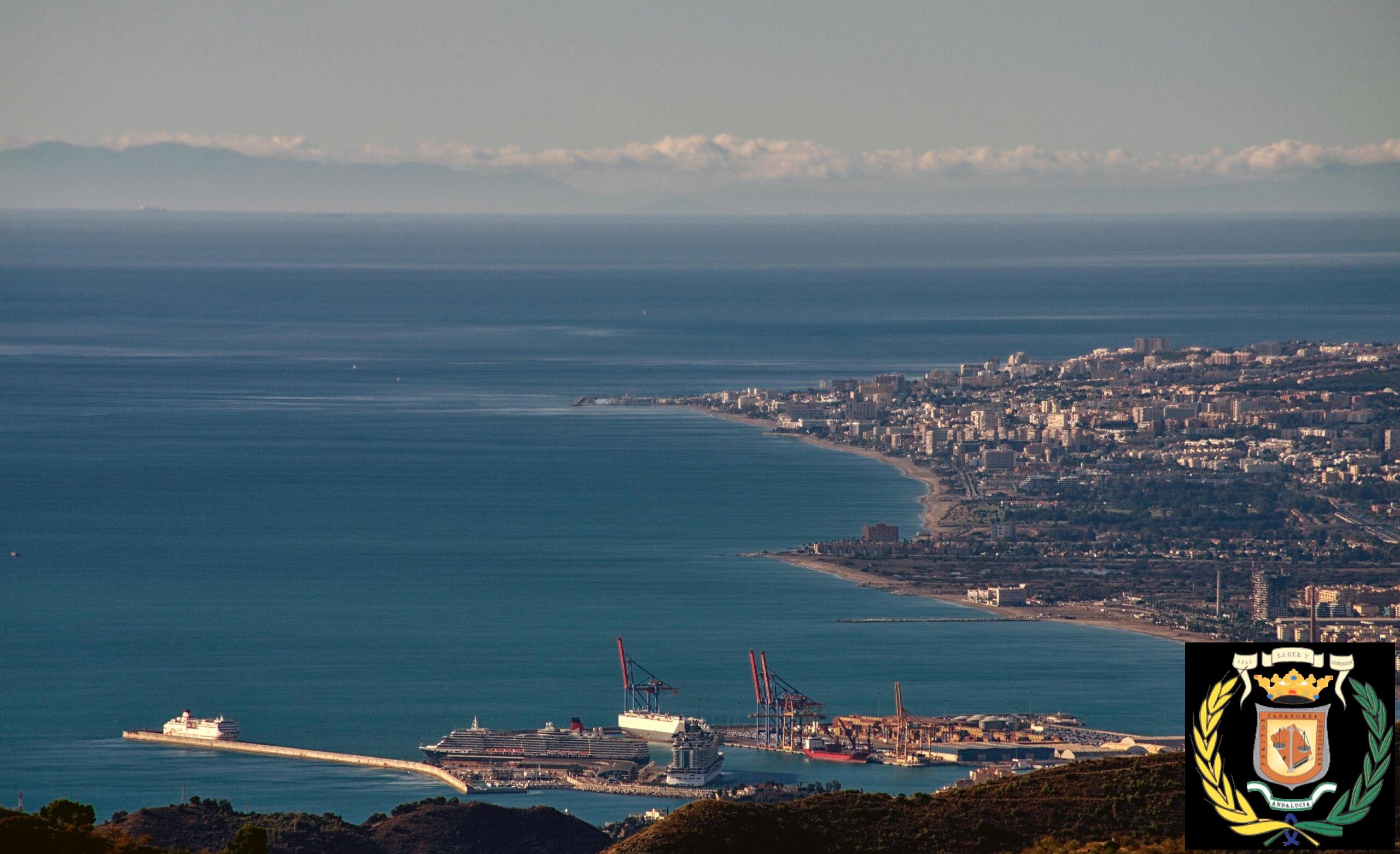 A breathtaking aerial cityscape showcasing Málaga's beautiful coastline and bustling port.